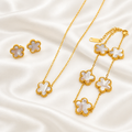 White five-petal flower necklace, bracelet and earrings on white satin