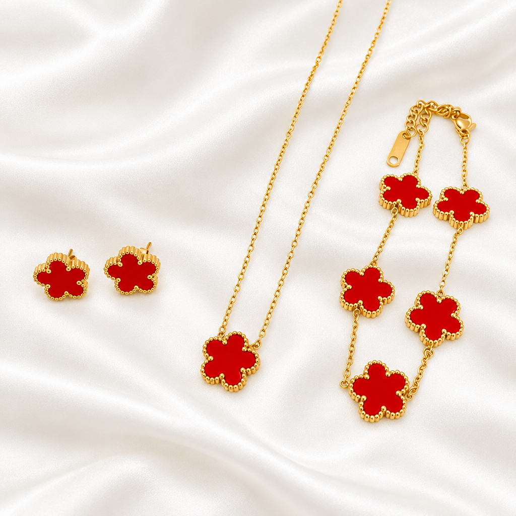Red five-petal flower necklace, bracelet and earrings on white satin