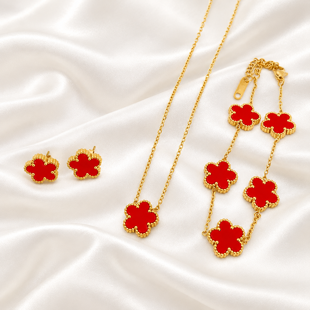 Red flower pendant necklace, bracelet and matching earrings on satin
