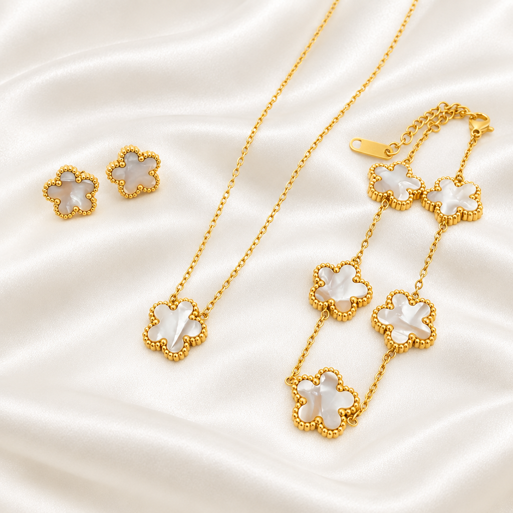 White flower pendant necklace, bracelet and matching earrings on satin